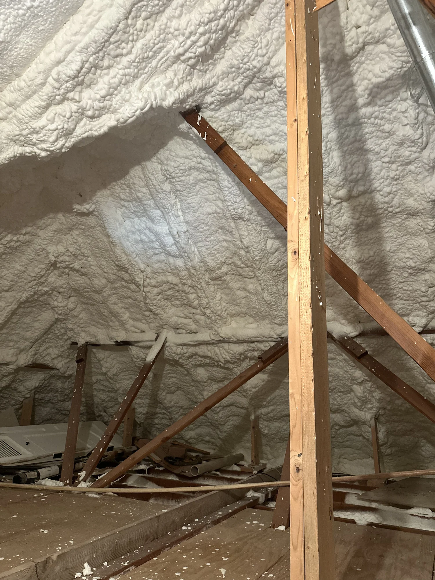 Spray foam insulation on an attic roof deck and gable wall