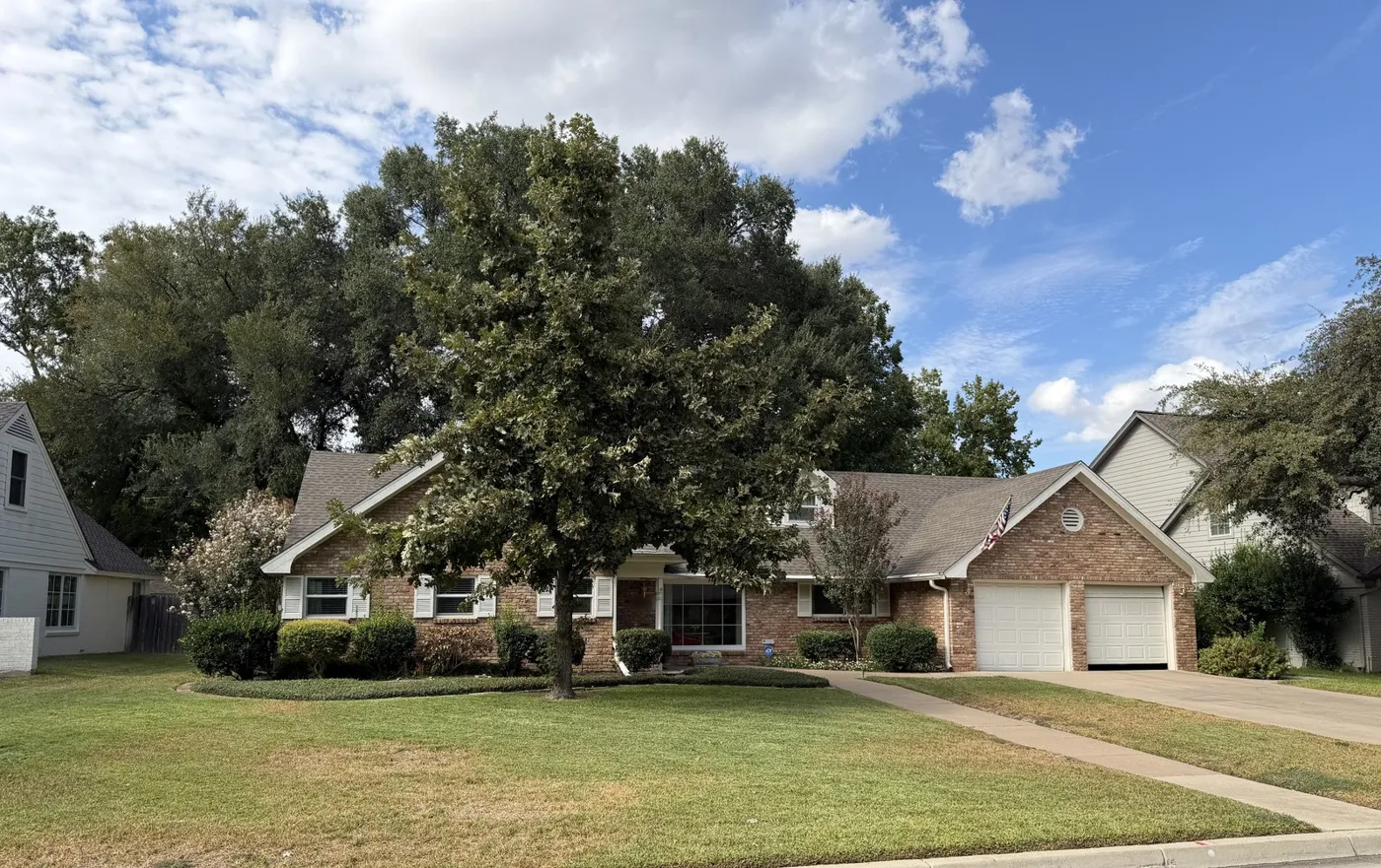 Brick home with a two-car garage in Tanglewood, Fort Worth, after an attic insulation retrofit