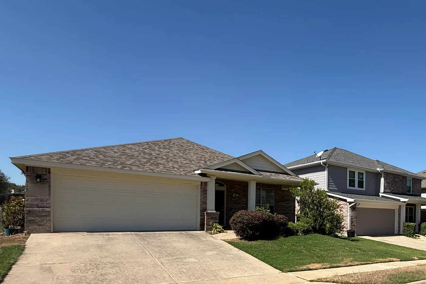 One-story and two-story brick homes side by side in The Ranches, Fort Worth, where Top Gun Insulation completed an attic insulation retrofit